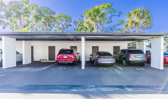 a view of a cars park in front of a building