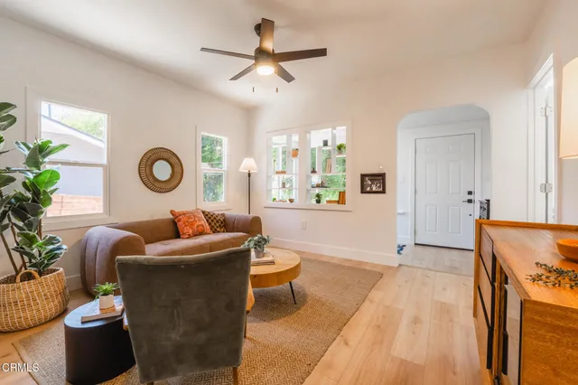 a living room with furniture and a clock