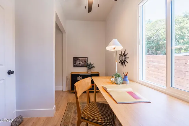 a view of a room with furniture and wooden floor