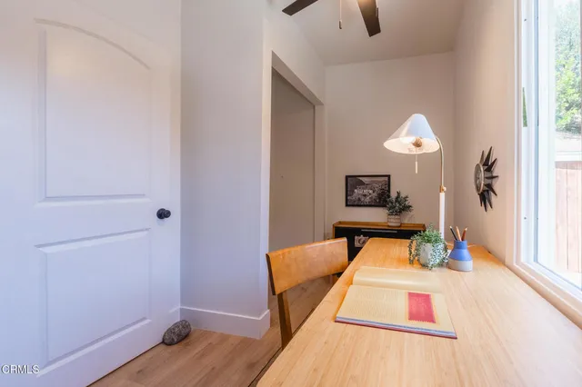 a living room with wooden floor and furniture