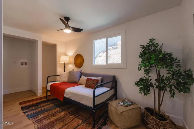 a bedroom with a bed and a potted plant