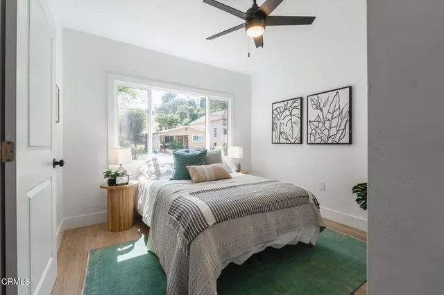 a bedroom with a bed and a window