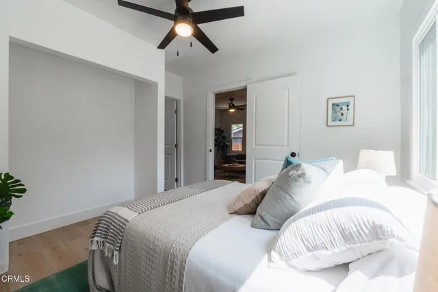 a bedroom with a bed and a chandelier