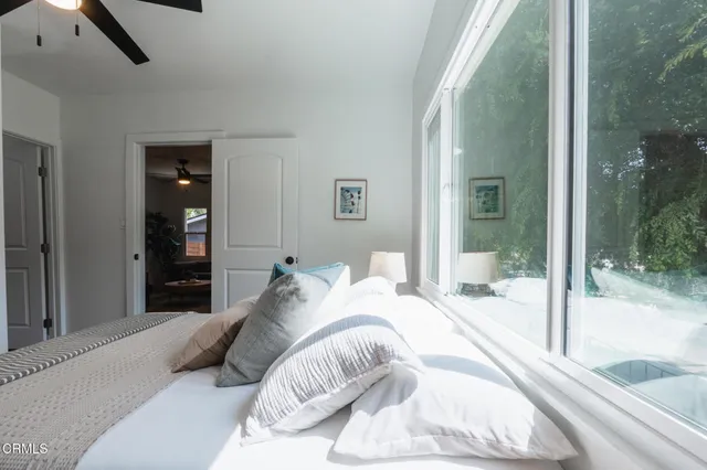 a bedroom with a bed and glass door