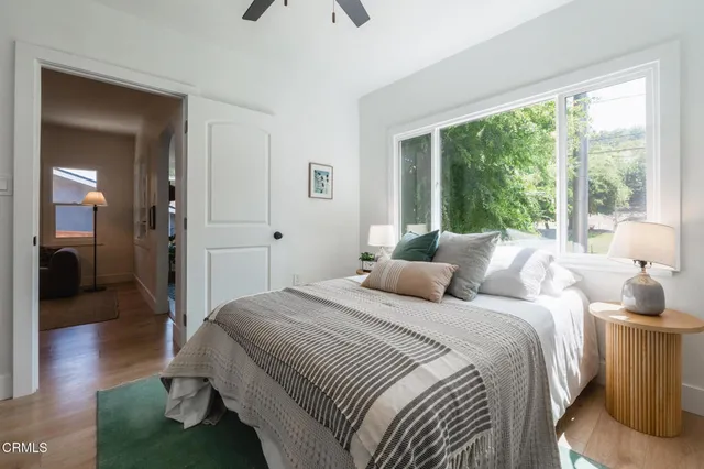 a bedroom with a bed and a large window