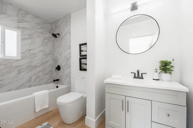 a bathroom with a sink toilet and a mirror