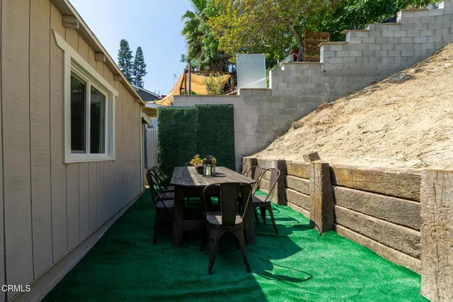 a view of backyard with seating area and green space