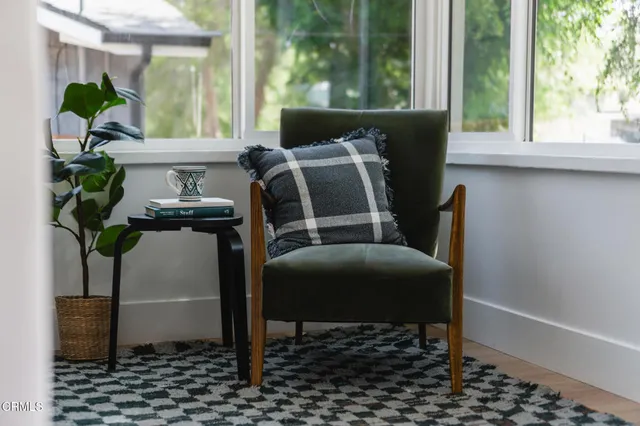 a dining room with furniture and a window