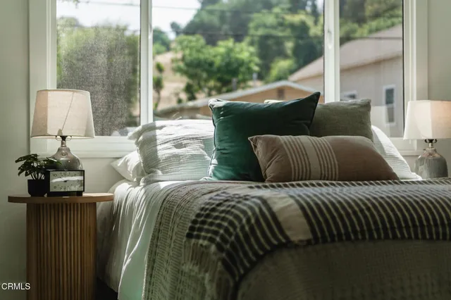a bedroom with bed and a window