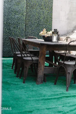 a view of a backyard with furniture and a garden
