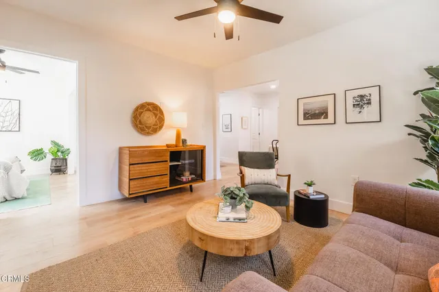 a living room with furniture a clock and a lamp