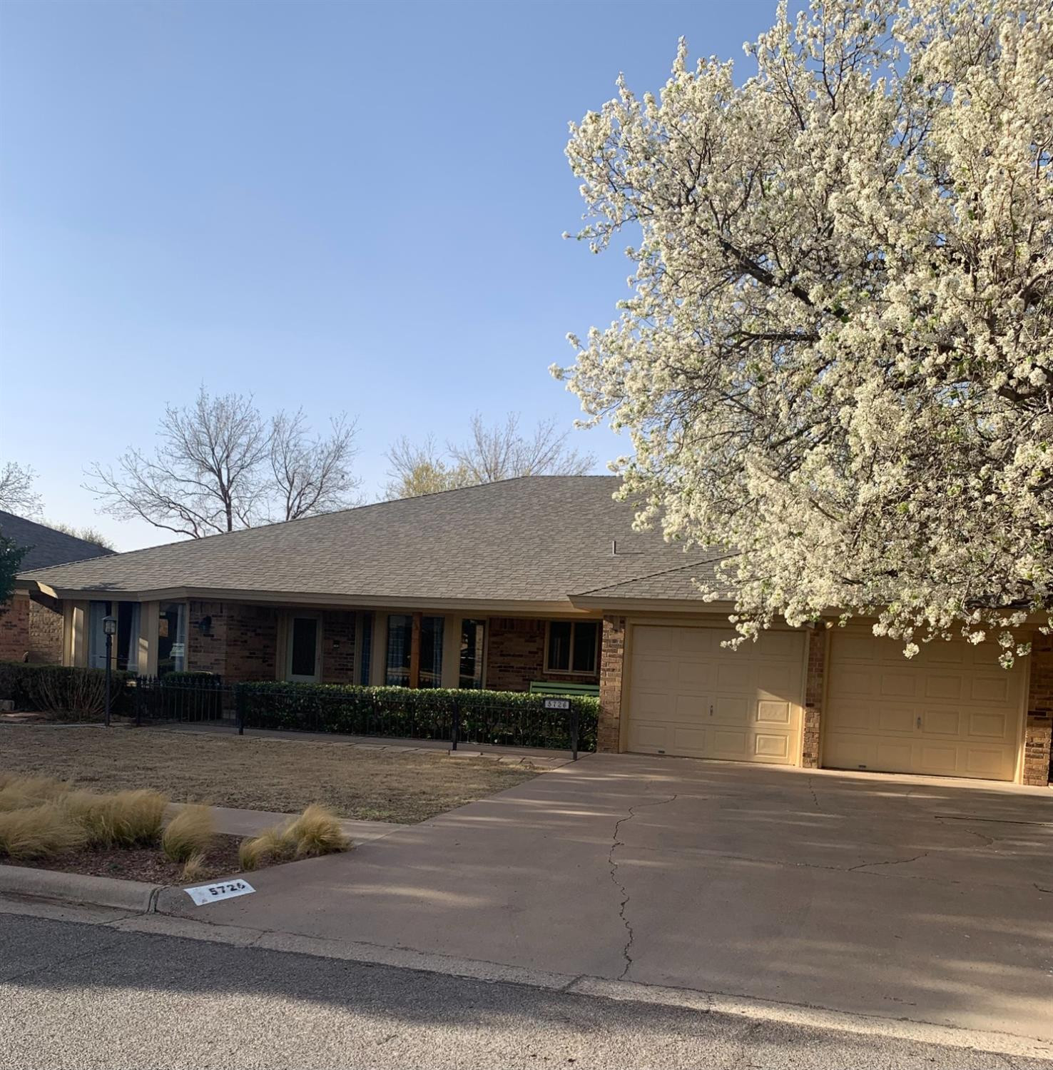 5726 70th Street Lubbock, TX 79424 - Photo 1 of 24 a front view of a house with a yard
