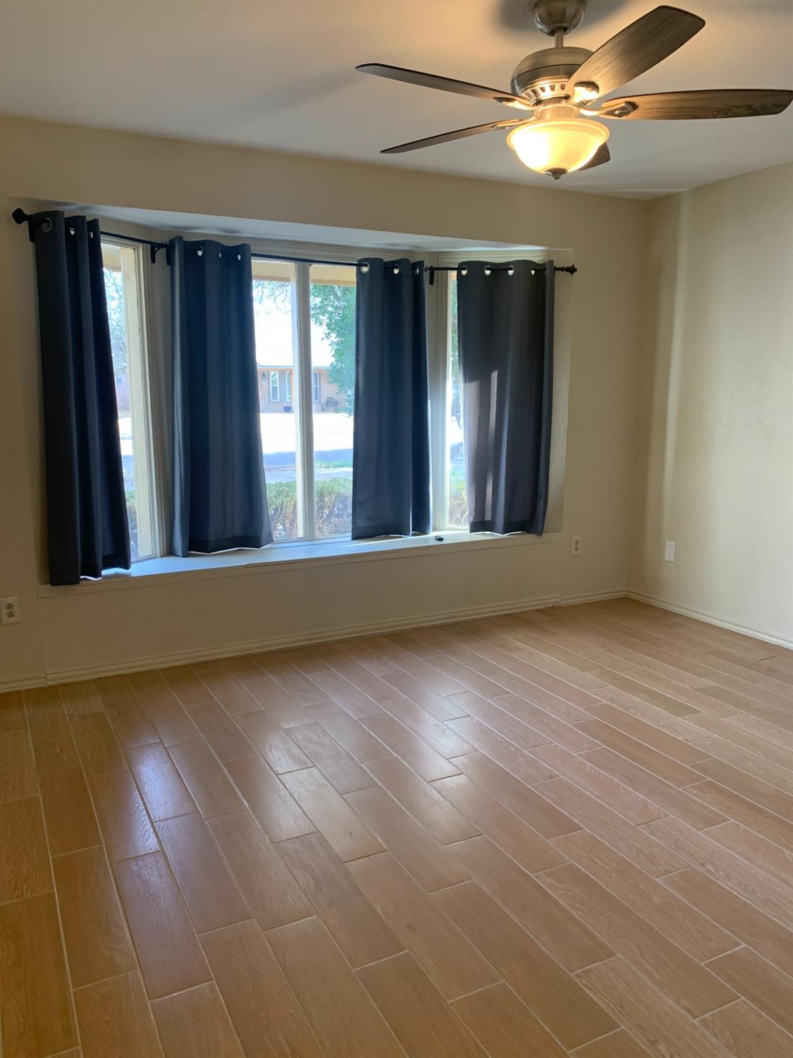5726 70th Street Lubbock, TX 79424 - Photo 11 of 24 a view of a room with large windows and a chandelier