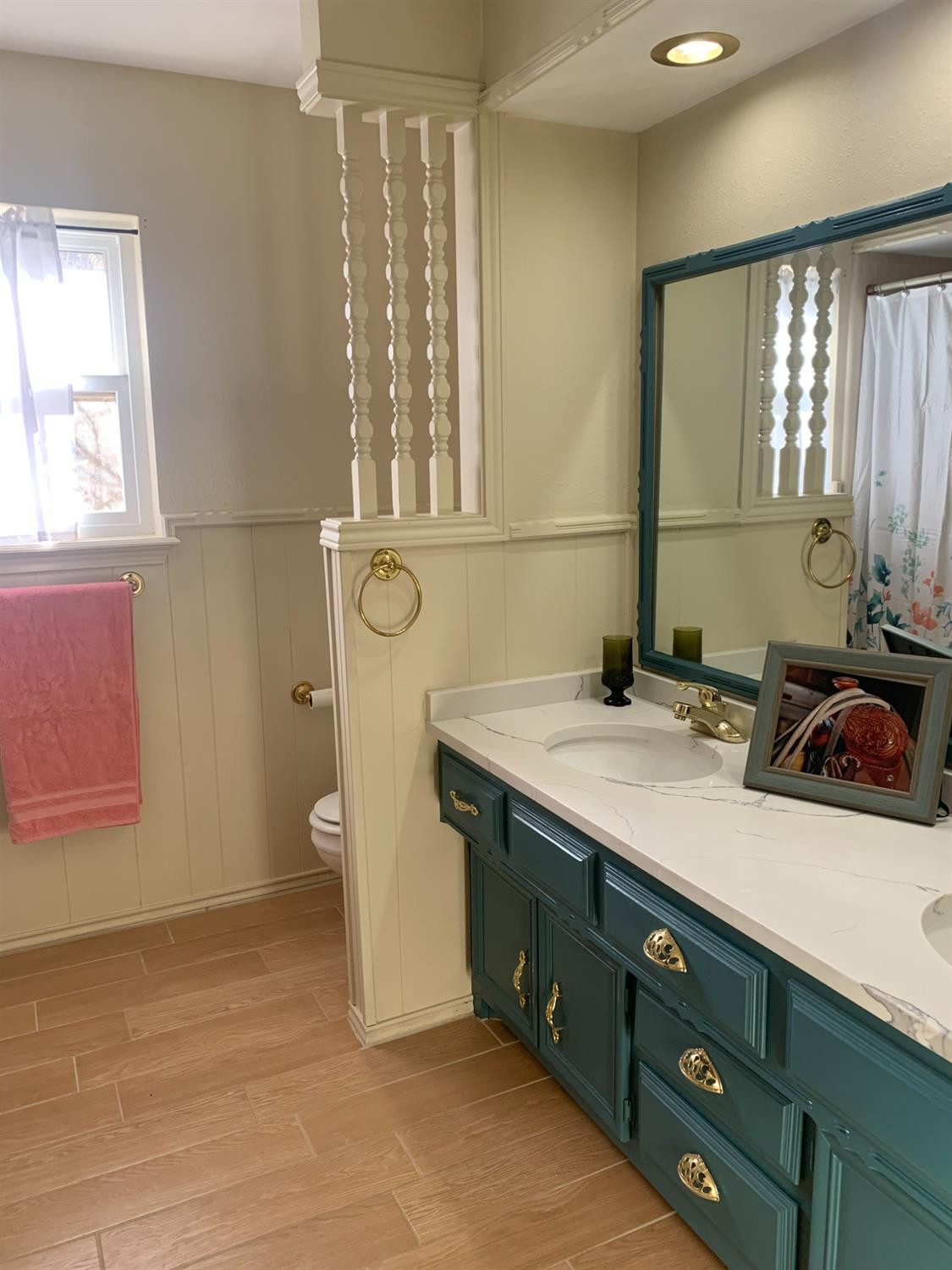5726 70th Street Lubbock, TX 79424 - Photo 13 of 24 a bathroom with a sink and a mirror