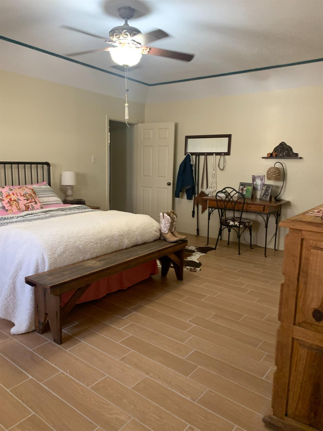 5726 70th Street Lubbock, TX 79424 - Photo 15 of 24 a bedroom with furniture and a mirror