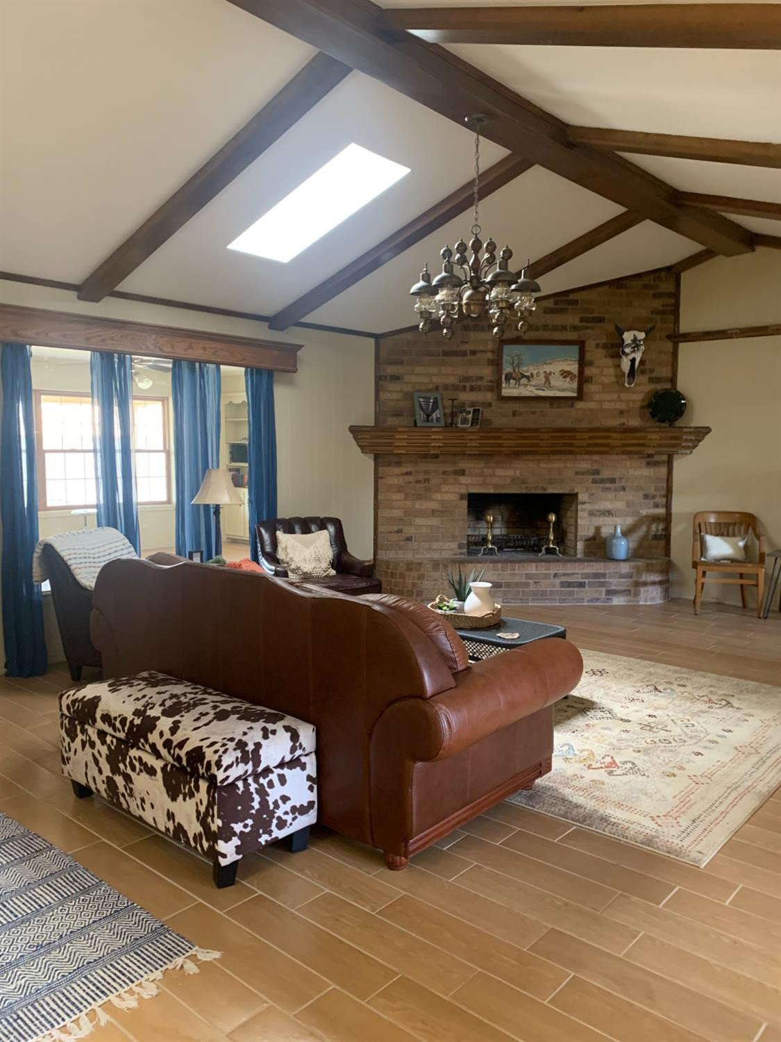 5726 70th Street Lubbock, TX 79424 - Photo 5 of 24 a living room with furniture and a fireplace