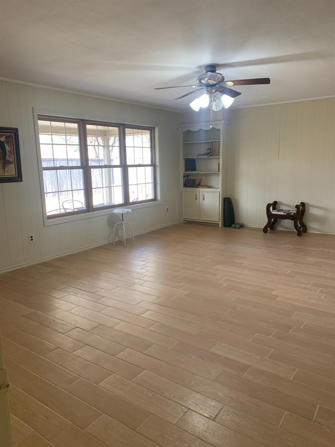 5726 70th Street Lubbock, TX 79424 - Photo 8 of 24 a view of a livingroom with a ceiling fan and window