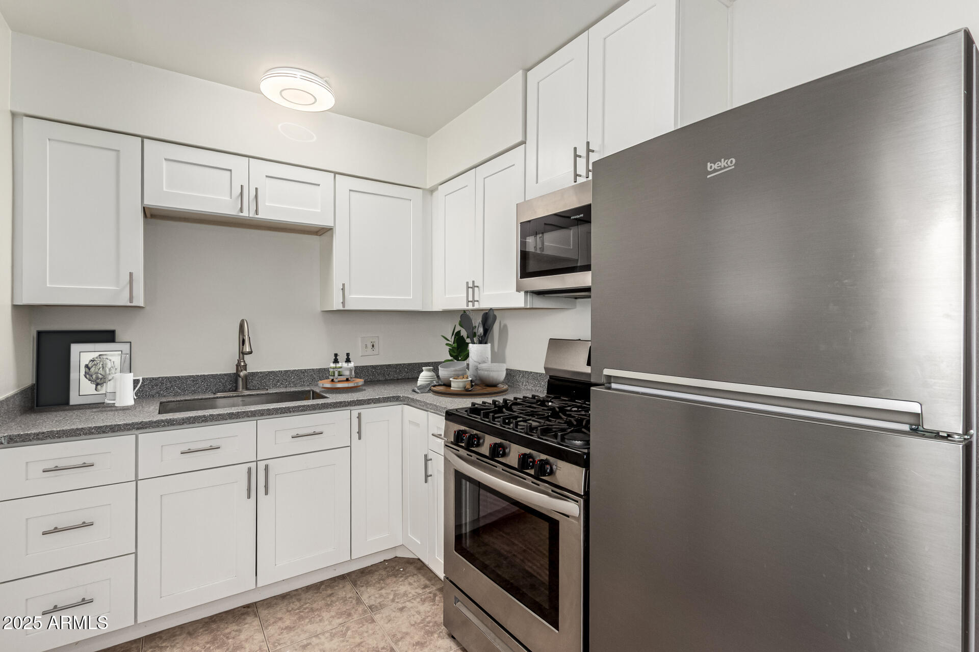 3540 East Montecito Avenue, Unit 3 Phoenix, AZ 85018 - Photo 11 of 23 a kitchen with appliances a sink and cabinets