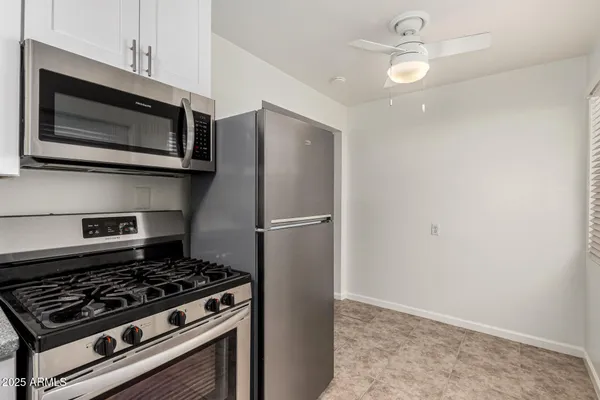 a kitchen with a stainless steel appliances and cabinets