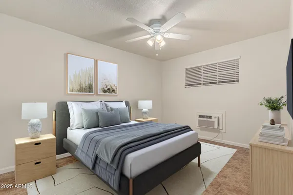 a bedroom with a large bed and a chandelier