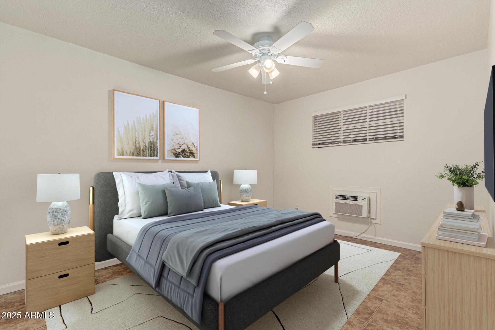 3540 East Montecito Avenue, Unit 3 Phoenix, AZ 85018 - Photo 14 of 23 a bedroom with a large bed and a chandelier