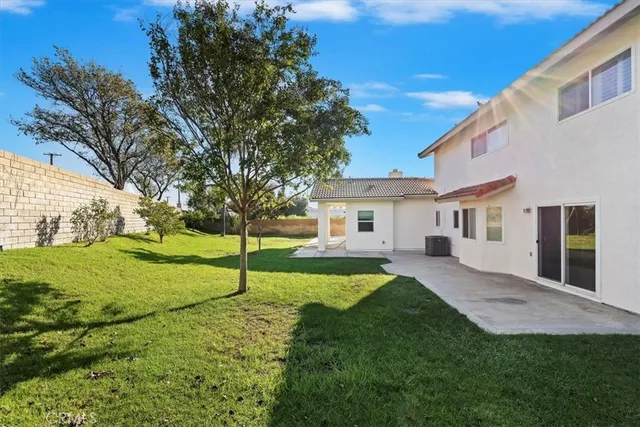 a house view with a sitting space and garden