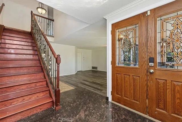 a view of entryway and hall with wooden floor