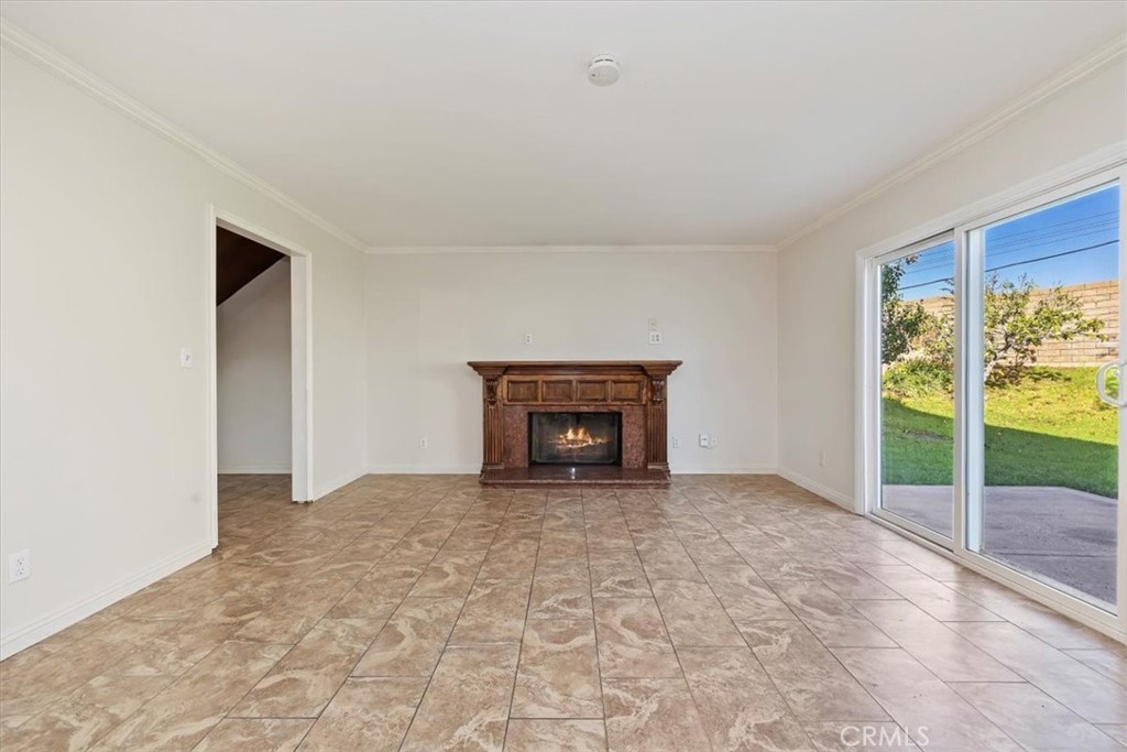 908 West Mesa Drive Rialto, CA 92376 - Photo 15 of 20 a view of an empty room with a fireplace and a window