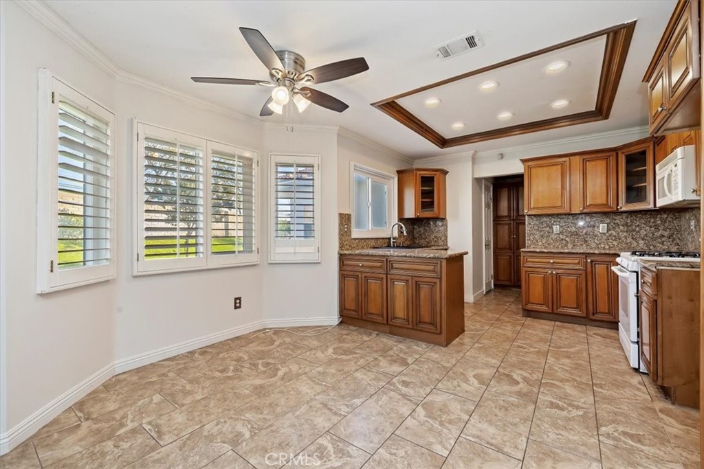 908 West Mesa Drive Rialto, CA 92376 - Photo 17 of 20 a kitchen with granite countertop a stove sink and cabinets