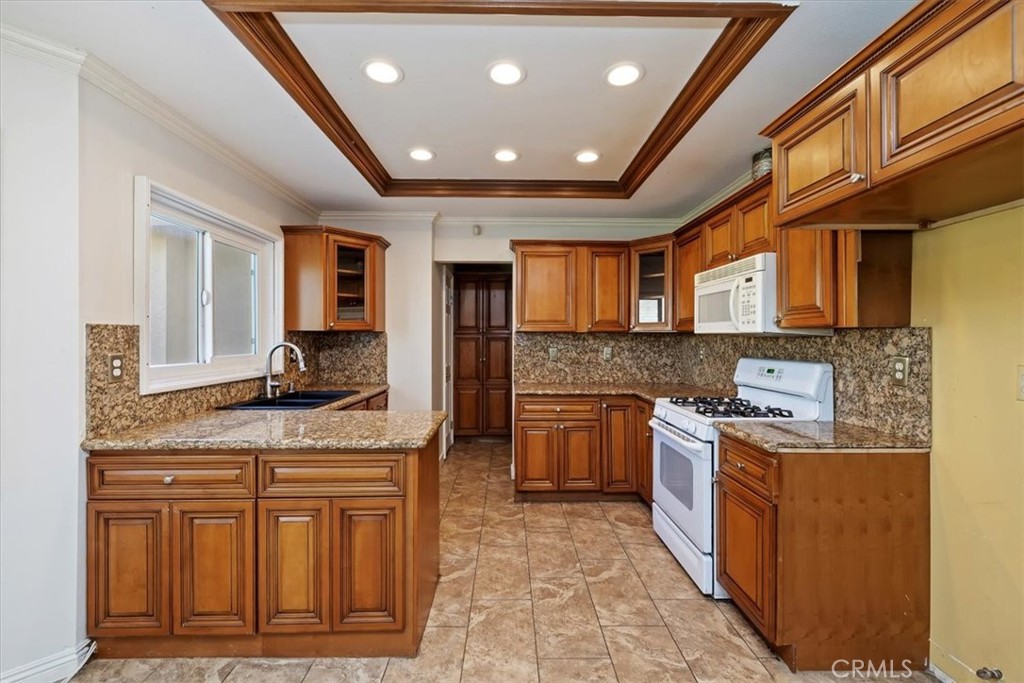 908 West Mesa Drive Rialto, CA 92376 - Photo 18 of 20 a kitchen with stainless steel appliances granite countertop a stove sink and cabinets