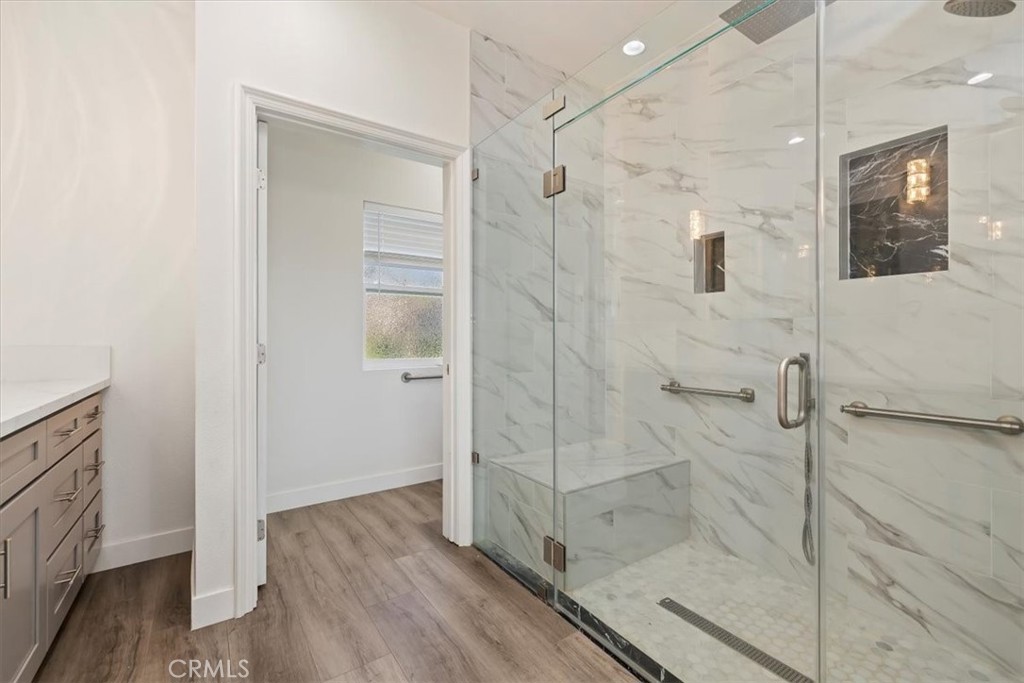 908 West Mesa Drive Rialto, CA 92376 - Photo 6 of 20 a bathroom with a glass shower door and a bathtub