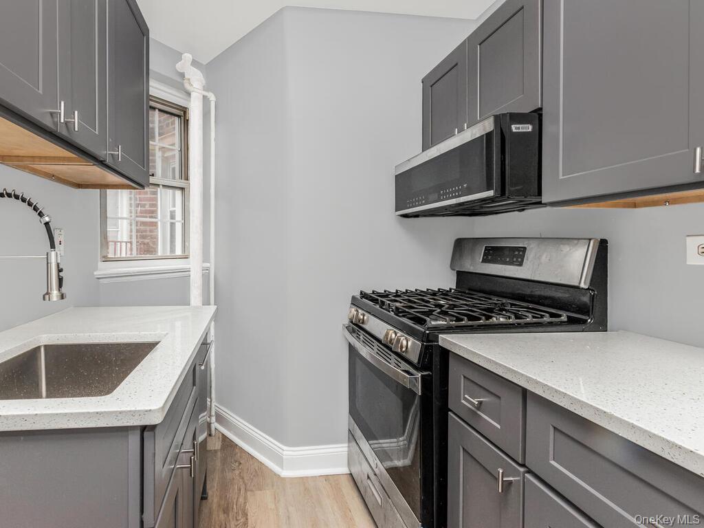 208 Centre Avenue, Unit 5K New Rochelle, NY 10805 - Photo 5 of 10 a kitchen with a stove and a sink