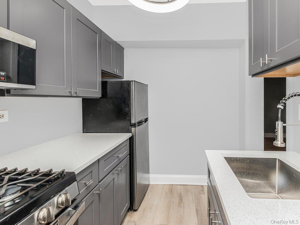 208 Centre Avenue, Unit 5K New Rochelle, NY 10805 - Photo 6 of 10 a kitchen with a sink and a stove top oven
