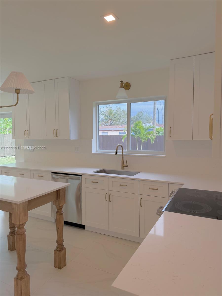 19221 Southwest 92nd Road Cutler Bay, FL 33157 - Photo 12 of 30 a kitchen with sink cabinets and window
