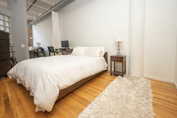 a bed room with a bed and a night stand