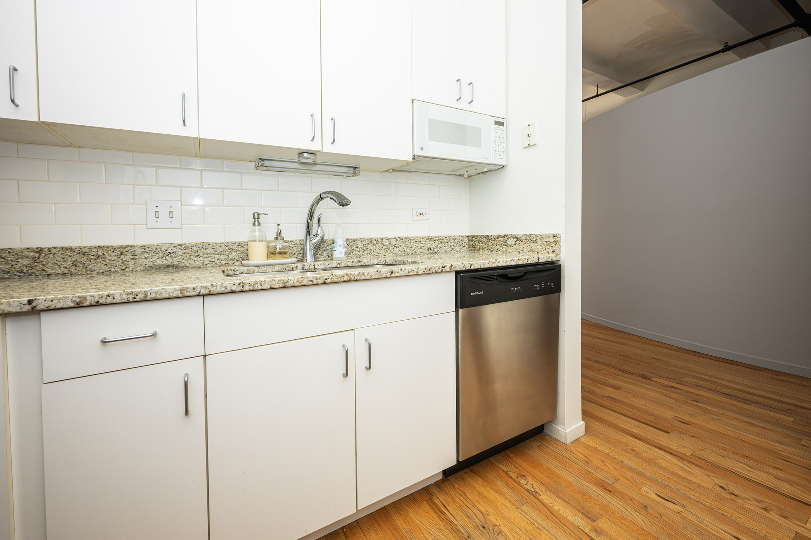 1000 West Washington Boulevard, Unit 411 Chicago, IL 60607 - Photo 17 of 20 a kitchen with stainless steel appliances granite countertop a sink and a refrigerator