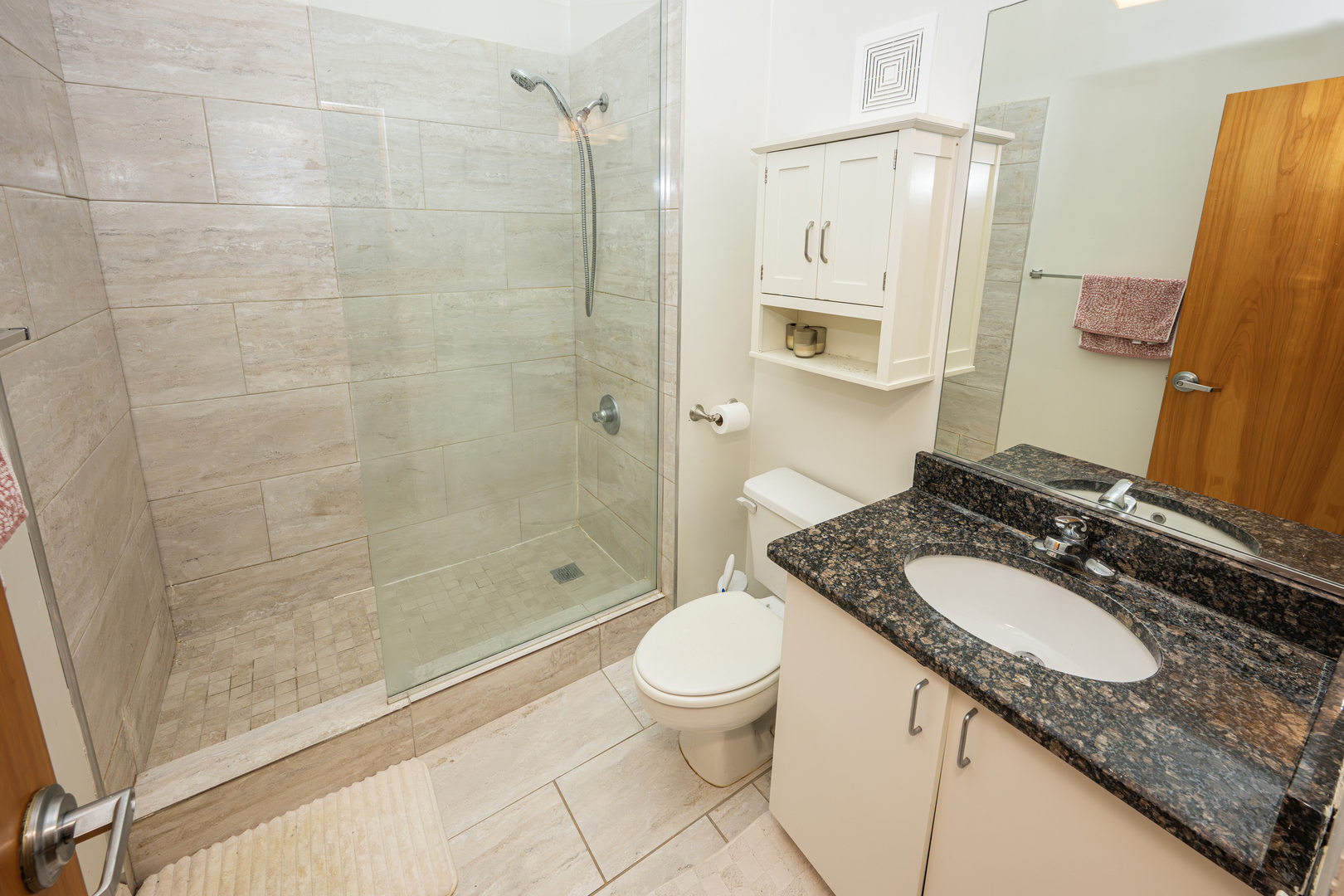 1000 West Washington Boulevard, Unit 411 Chicago, IL 60607 - Photo 20 of 20 a bathroom with a granite countertop sink a toilet and shower