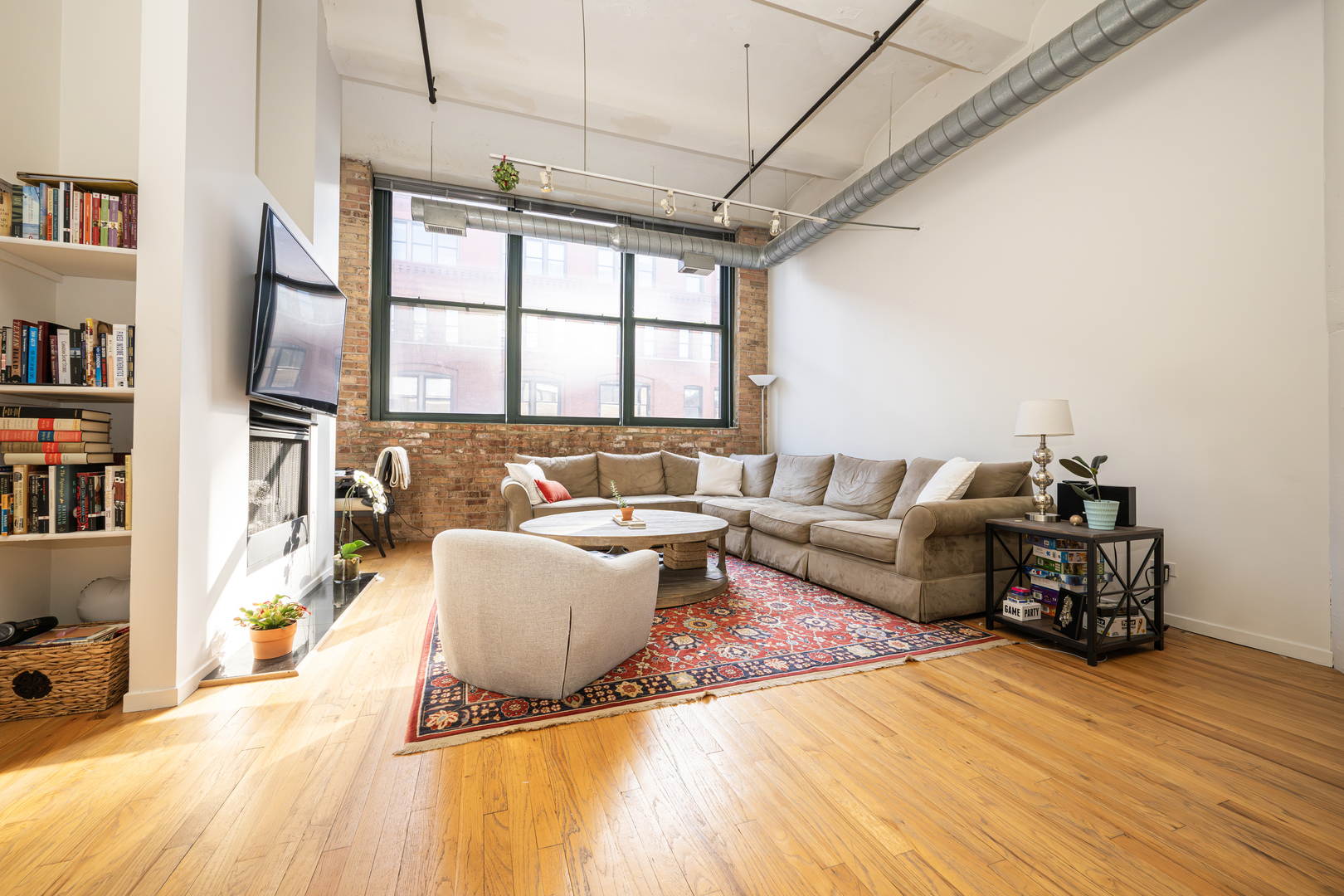 1000 West Washington Boulevard, Unit 411 Chicago, IL 60607 - Photo 4 of 20 a living room with furniture and a rug