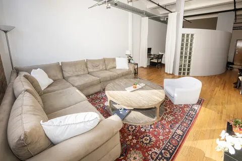 a living room with furniture and a rug