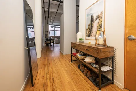 a view of a living room with furniture and wooden floor