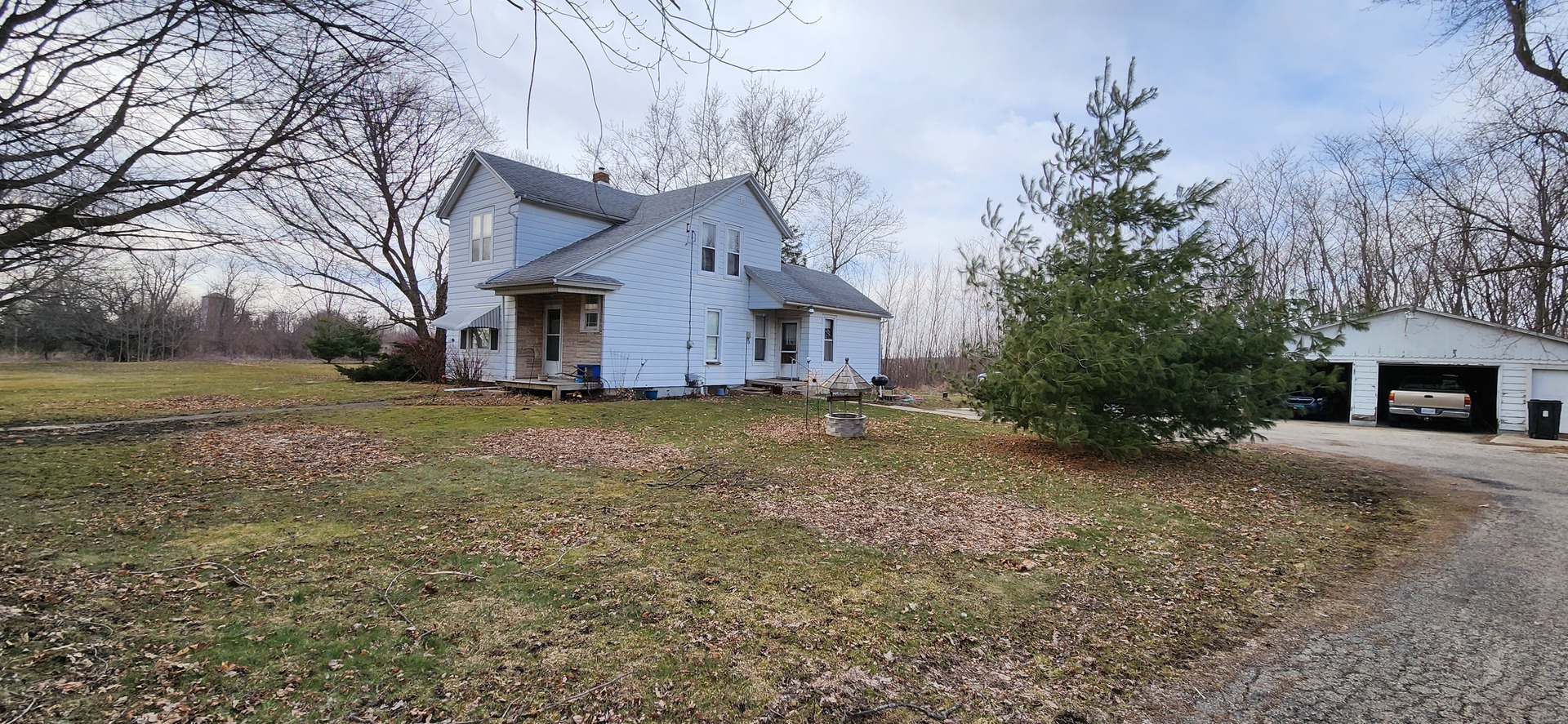 262 Palmyra Road Dixon, IL 61021 - Photo 2 of 4 a view of a house with a yard covered in the forest