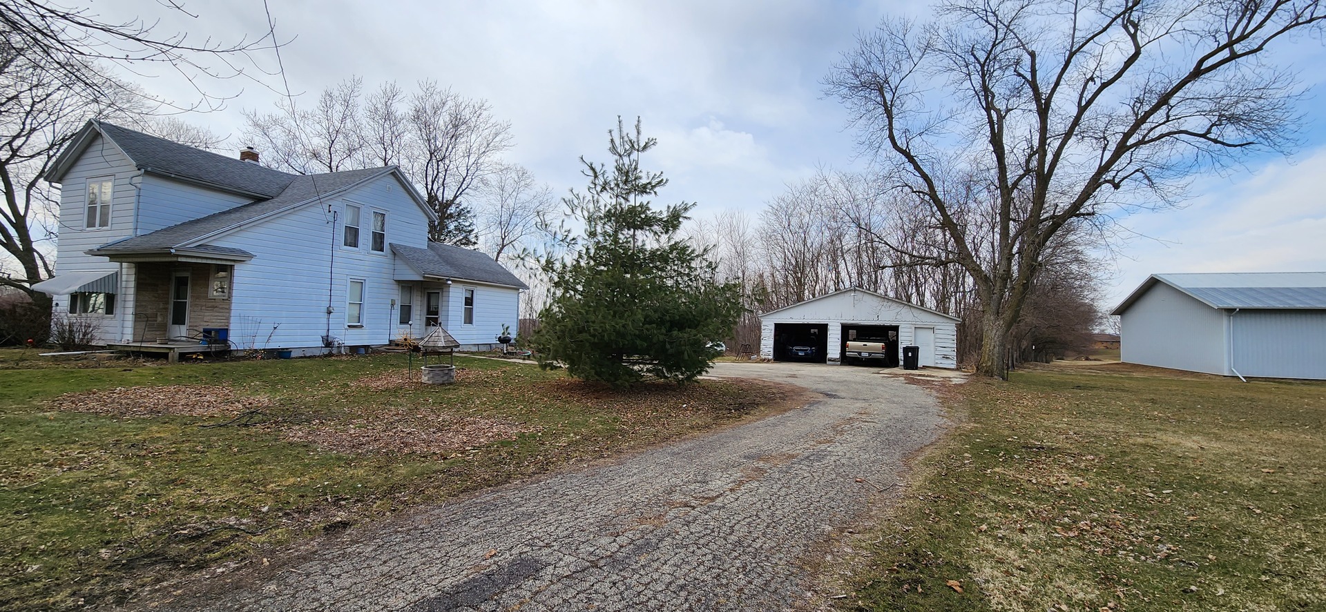 262 Palmyra Road Dixon, IL 61021 - Photo 4 of 4 a view of a house with a yard covered in the forest