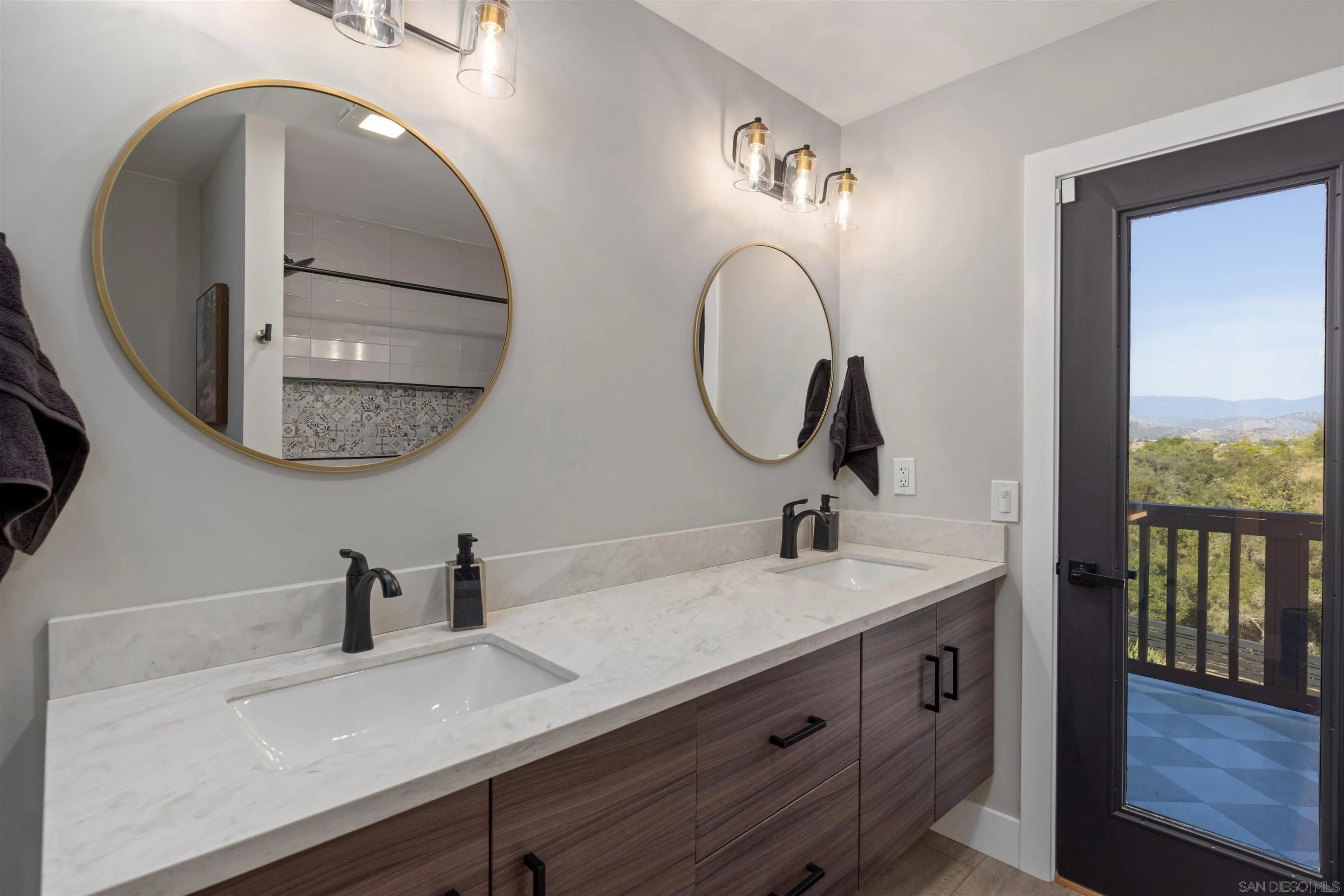 521 Rancho Camino Fallbrook, CA 92028 - Photo 42 of 72 a bathroom with a double vanity sink and a mirror