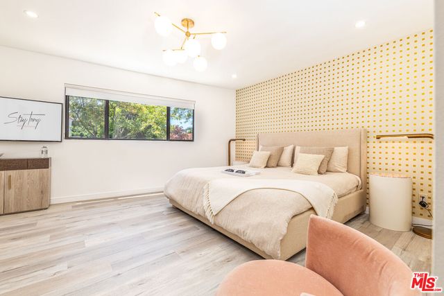 a bedroom with bed and window