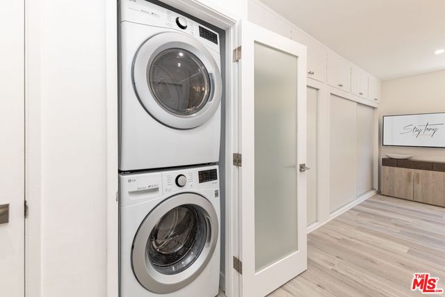 a view of a hallway with washer and dryer