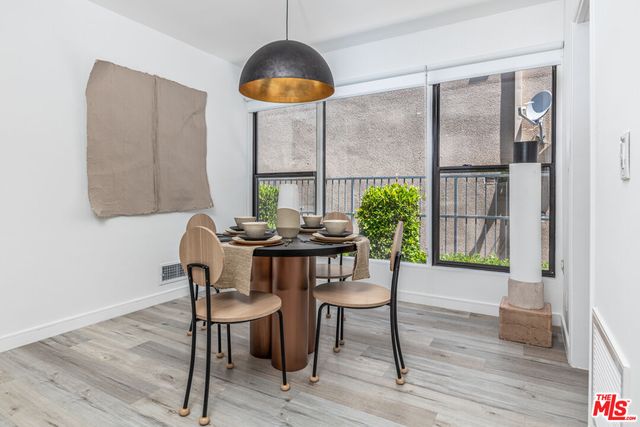 a view of a dining room with furniture window and wooden floor