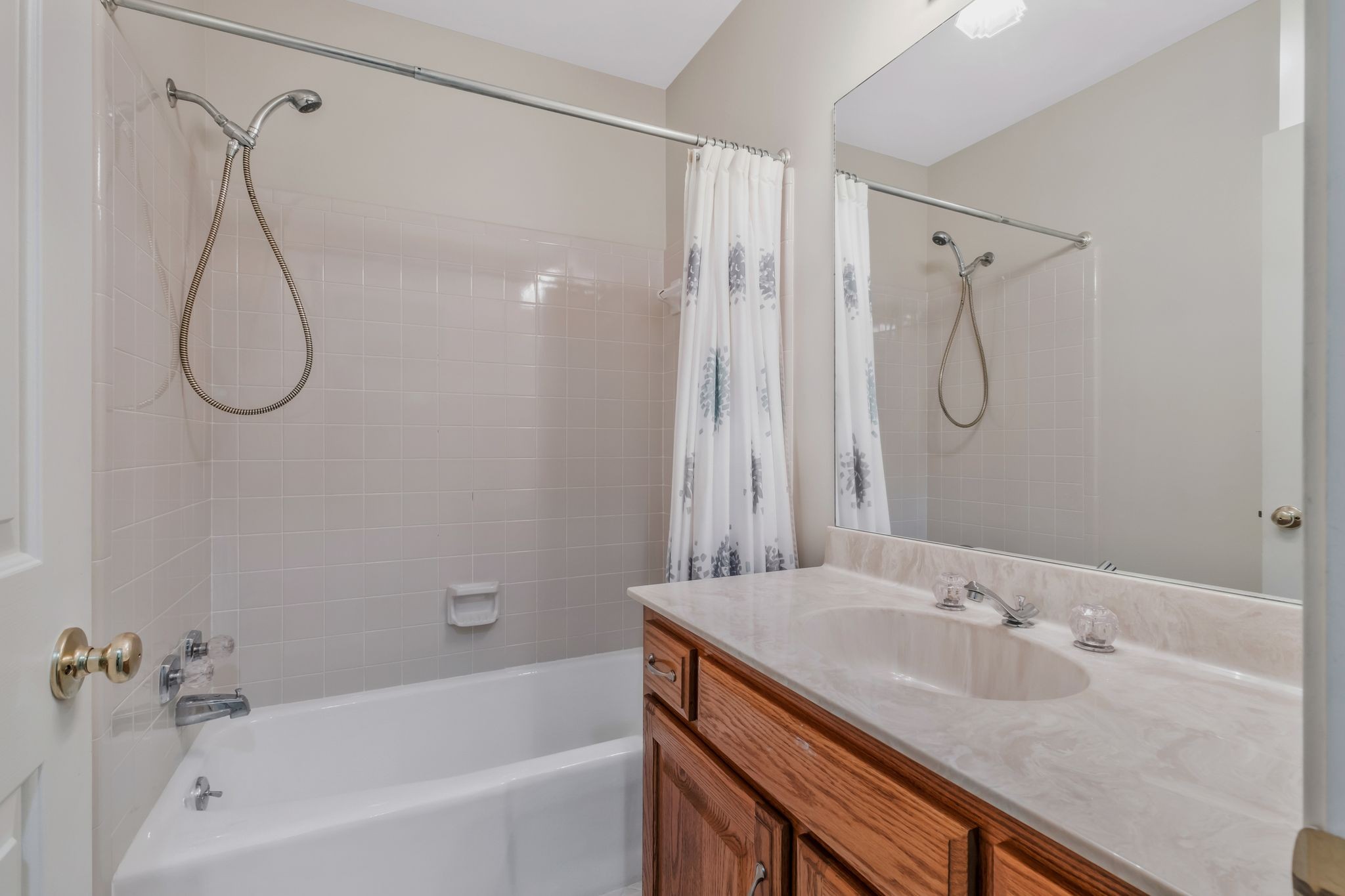 725 General George Patton Road Nashville, TN 37221 - Photo 23 of 32 a bathroom with a granite countertop sink a shower and a mirror