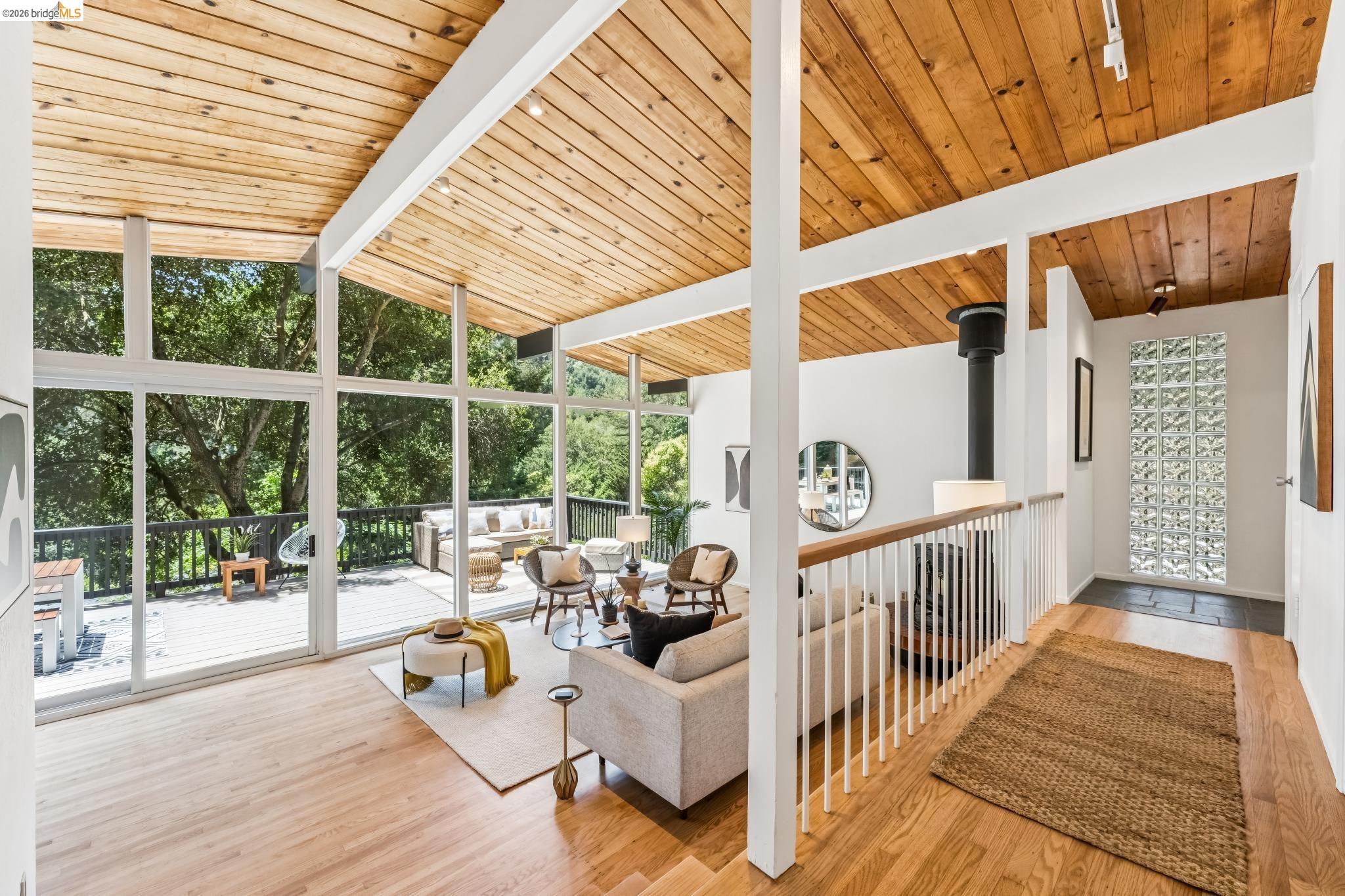 6645 Heather Ridge Way Oakland, CA 94611 - Photo 14 of 61 Vaulted wood-plank ceilings complement the light wood-finish flooring