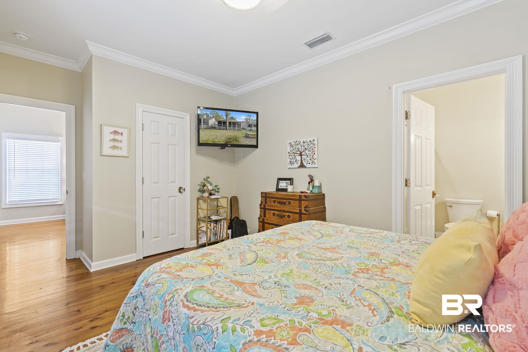 17341 Cabin Road Loxley, AL 36551 - Photo 25 of 49 Bedroom with ensuite bath, hardwood / wood-style floors, and crown molding