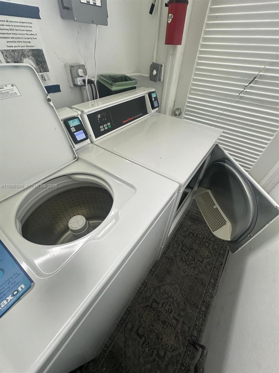 9848 Marina Boulevard, Unit 811 Boca Raton, FL 33428 - Photo 75 of 86 a utility room with dryer and washer
